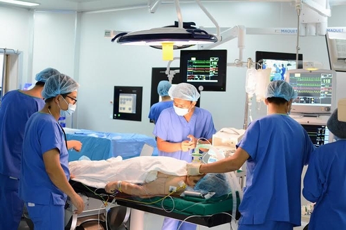 Ekip các bác sỹ Vinmec Central Park và chuyên gia nước ngoài đang tiến hành thay van tim cho bệnh nhân bằng phương pháp thay van động mạch chủ qua da.