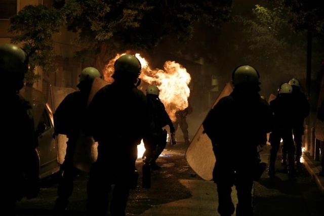 Một quả bom xăng phát nổ bên cạnh cảnh sát chống bạo động trong các cuộc đụng độ sau một cuộc mít tinh kỷ niệm vụ bắn súng vào cảnh sát năm 2008 của một sinh viên 15 tuổi, Alexandros Grigoropoulos, ở Athens, Hy Lạp, ngày 6/12/2017. Ảnh: Reuters