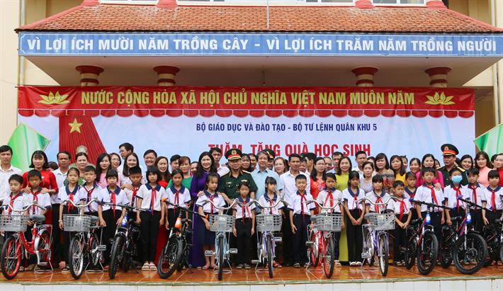 Bộ trưởng Nguyễn Kim Sơn và Trung tướng Thái Đại Ngọc, Tư lệnh Quân khu 5 tặng quà cho học sinh Trường Tiểu học Nơ Trang Lơng, huyện Đắk Glong, tỉnh Đắk Nông