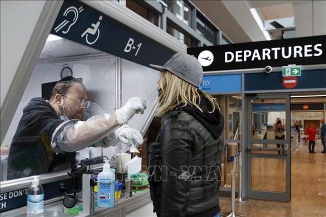 Nhân viên y tế lấy mẫu xét nghiệm Covid-19 cho hành khách tại sân bay Ben-Gurion ở Lod, Israel.
