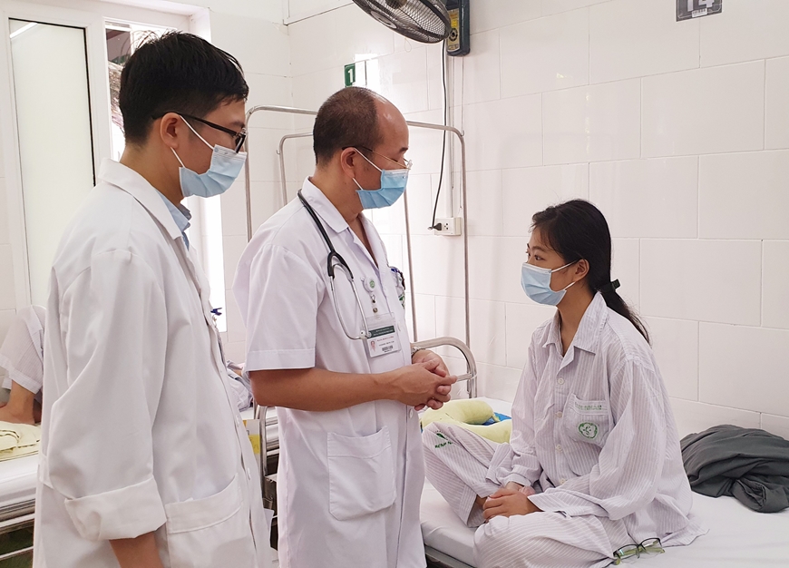 PGS.TS Đỗ Duy Cường - Giám đốc Trung tâm Bệnh nhiệt đới (áo trắng, ở giữa) thăm khám cho bệnh nhân đang điều trị tại Trung tâm