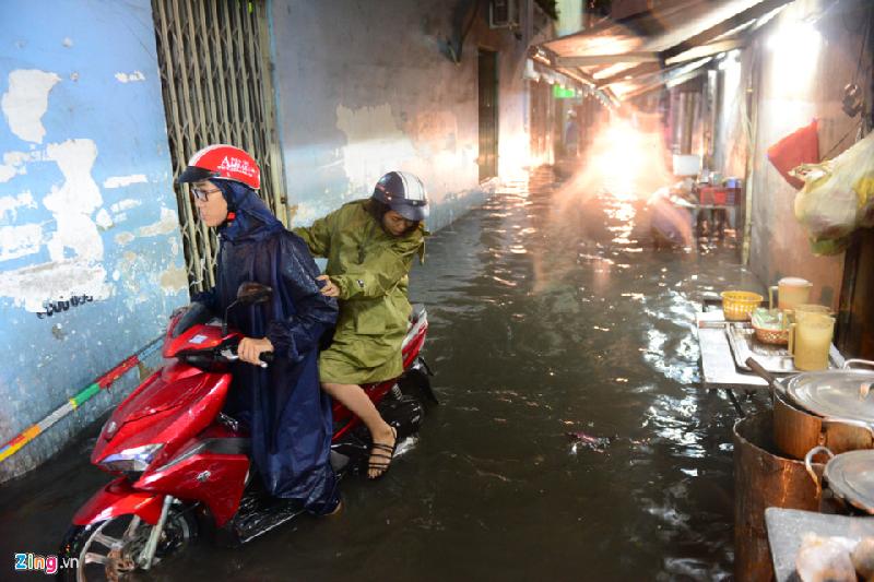 Trên đường Xô Viết Nghệ Tĩnh, quận Bình Thạnh, nước tràn vào trong hẻm. Nhiều nhà đóng cửa, việc buôn bán bị ngưng trệ.