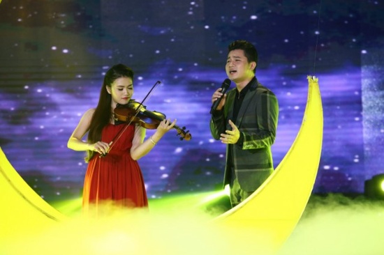 Nam ca sĩ Lâm Vũ trình diễn cùng nhạc công violon trên sân khấu.